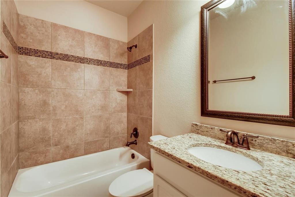 11929 Terraza Circle, Unit TH37 Austin, TX 78726 - Photo 14 of 17 a bathroom with a granite countertop tub sink and mirror