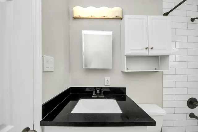 a kitchen with granite countertop a sink and a stove