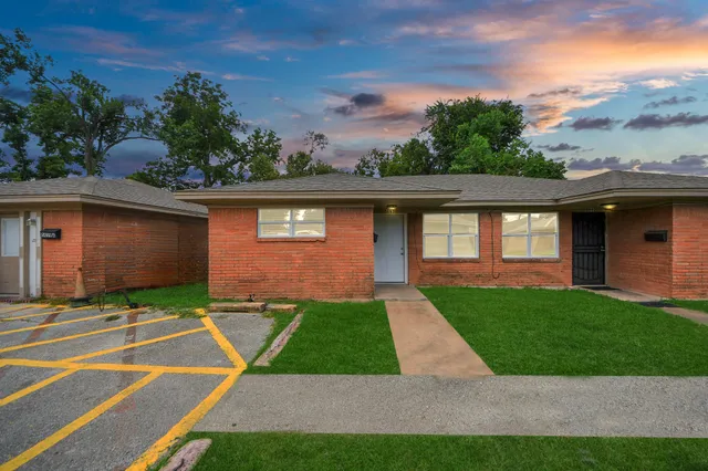 a view of backyard with swimming pool and seating space