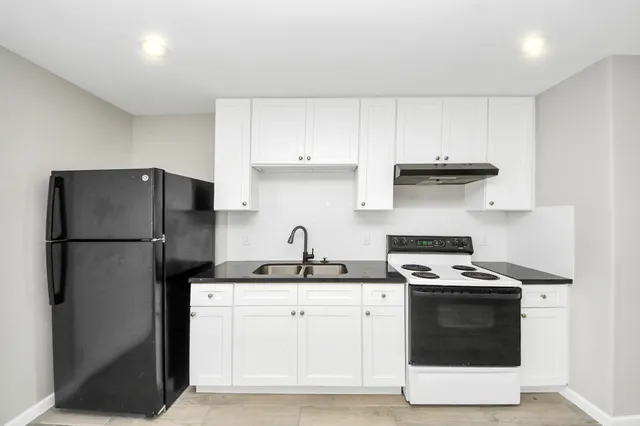 a kitchen with a sink a stove and refrigerator