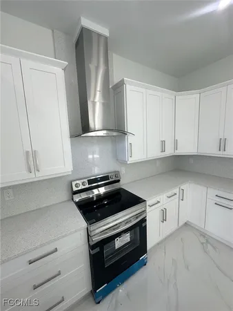 a kitchen with cabinets appliances and a window