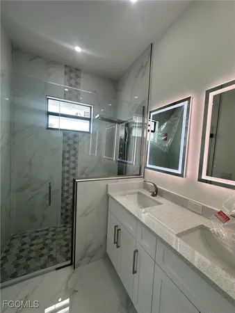 a bathroom with a granite countertop sink mirror and double