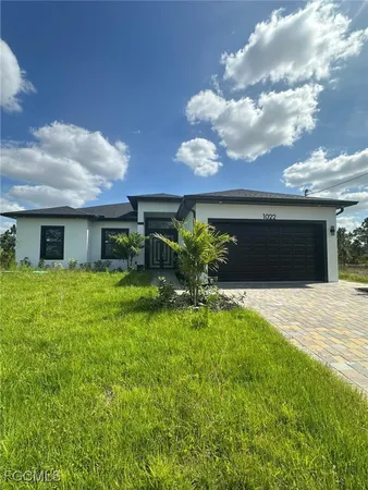 a front view of house with yard and green space