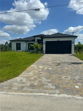 a front view of a house with a garden