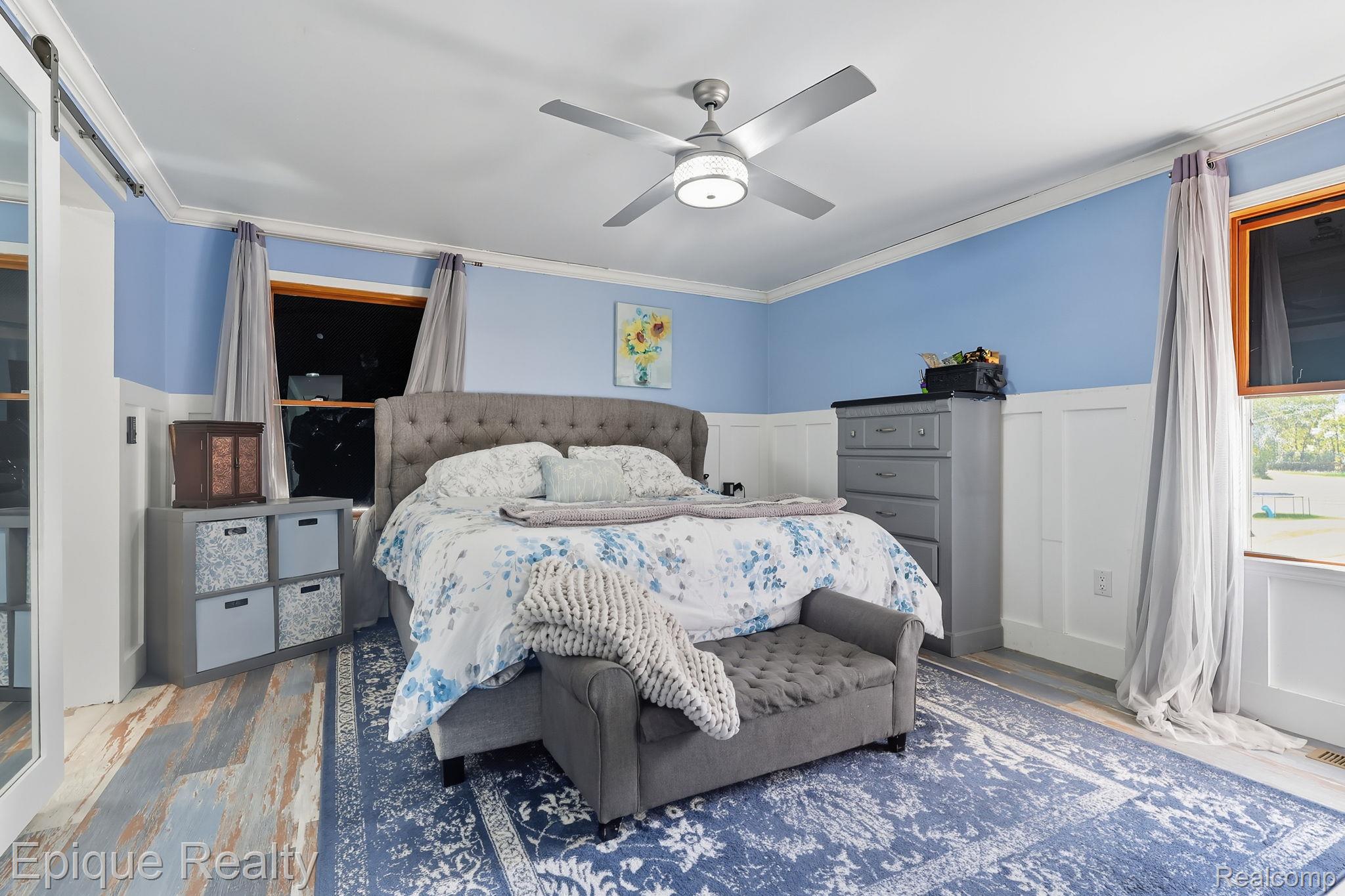 13265 Tibbets Road Memphis, MI 48041 - Photo 5 of 48 Bedroom with ornamental molding, wood finished floors, a ceiling fan, a wainscoted wall, and a decorative wall