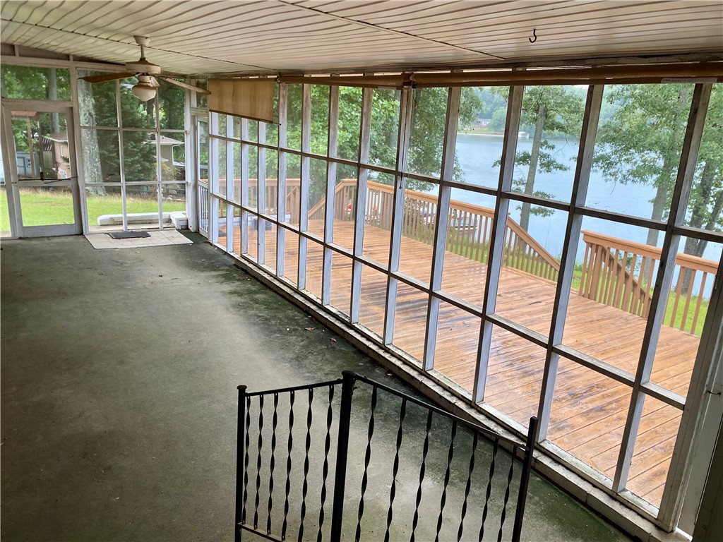 101 Deep Water Point Anderson, SC 29621 - Photo 26 of 34 A tranquil screened porch overlooks a large deck with steps descending to a scenic lake.