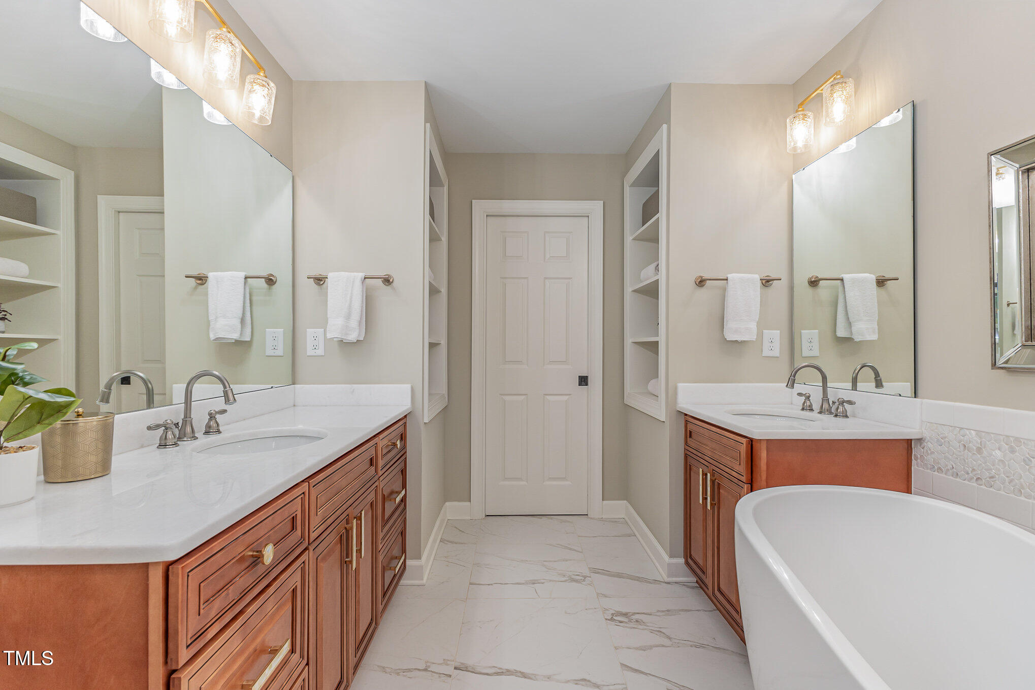 816 Thatcher Way Raleigh, NC 27615 - Photo 25 of 53 a bathroom with a double vanity sink a mirror and a bathtub