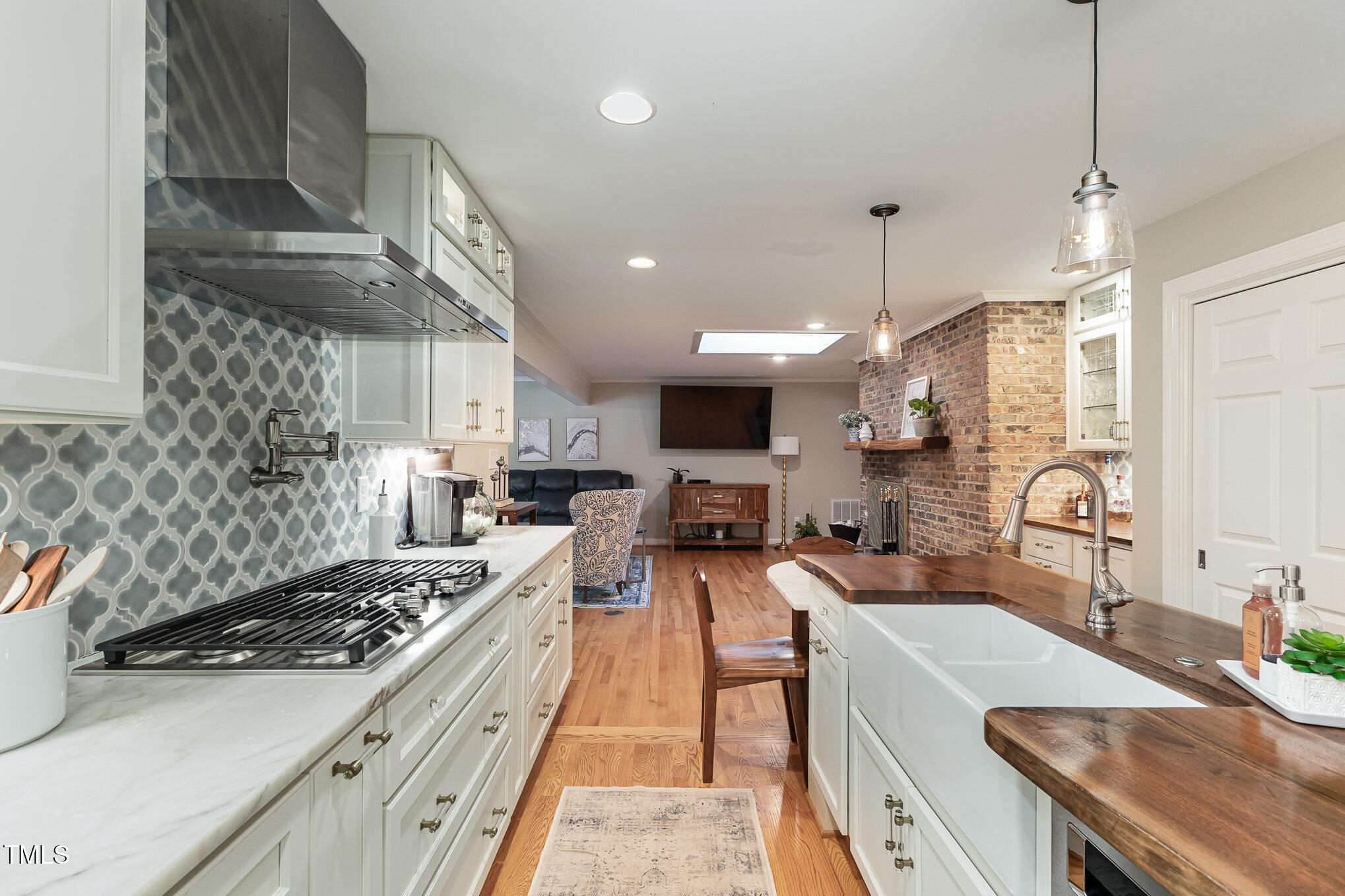 816 Thatcher Way Raleigh, NC 27615 - Photo 10 of 53 a open kitchen with stainless steel appliances granite countertop a sink a stove and a wooden floors