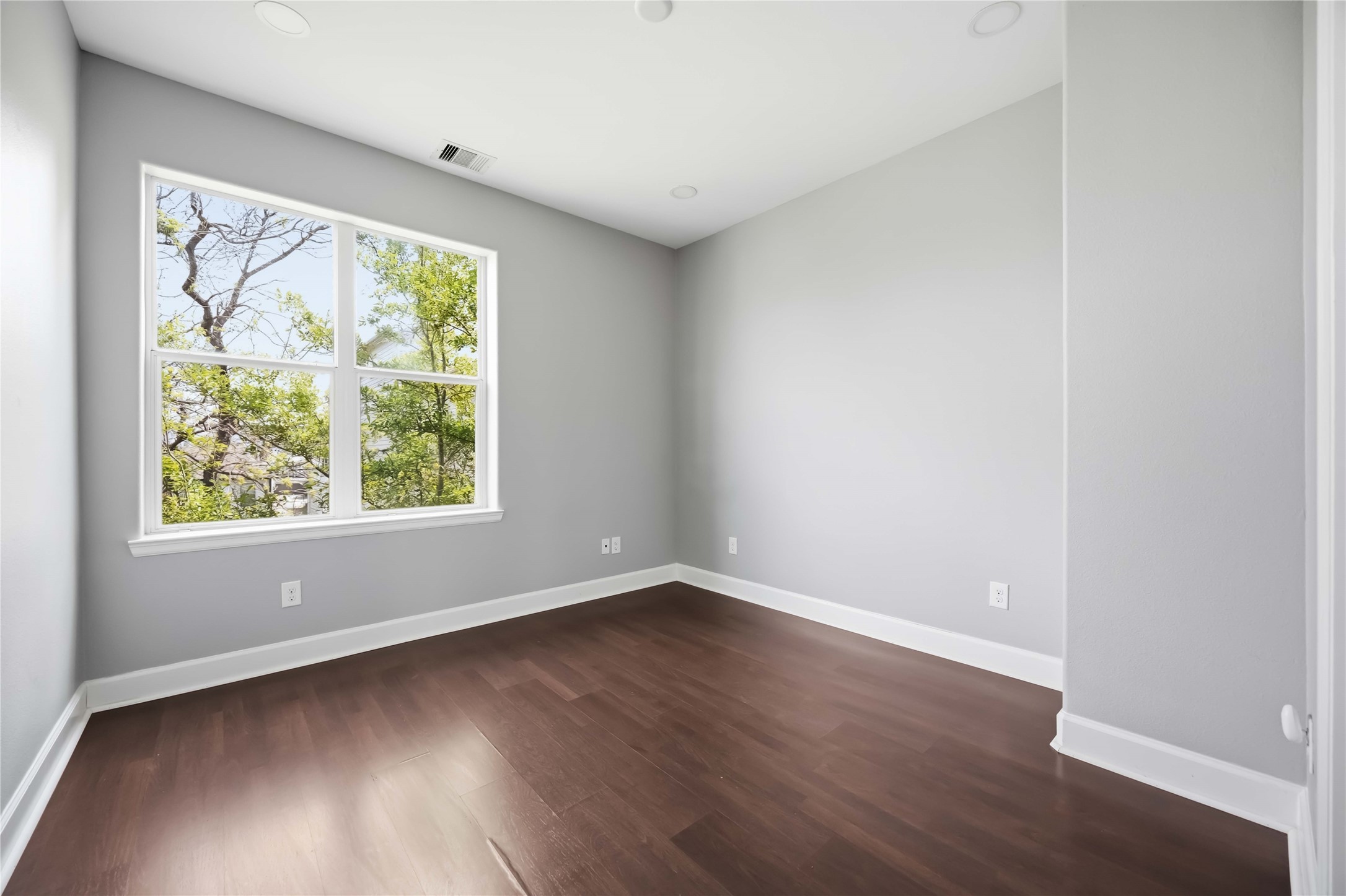 708 Schwartz Street Houston, TX 77020 - Photo 16 of 25 an empty room with wooden floor and windows