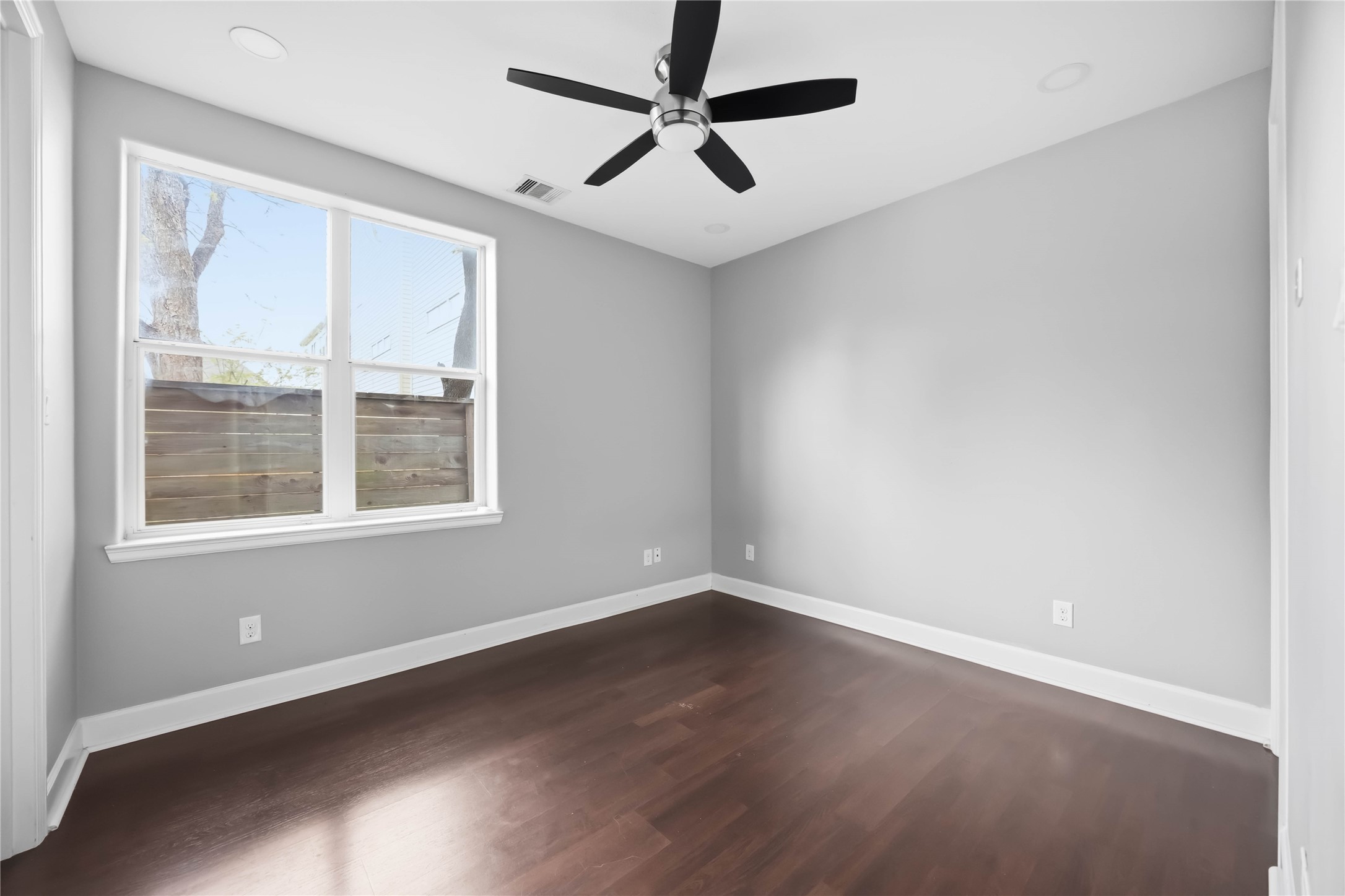 708 Schwartz Street Houston, TX 77020 - Photo 22 of 25 an empty room with wooden floor and windows