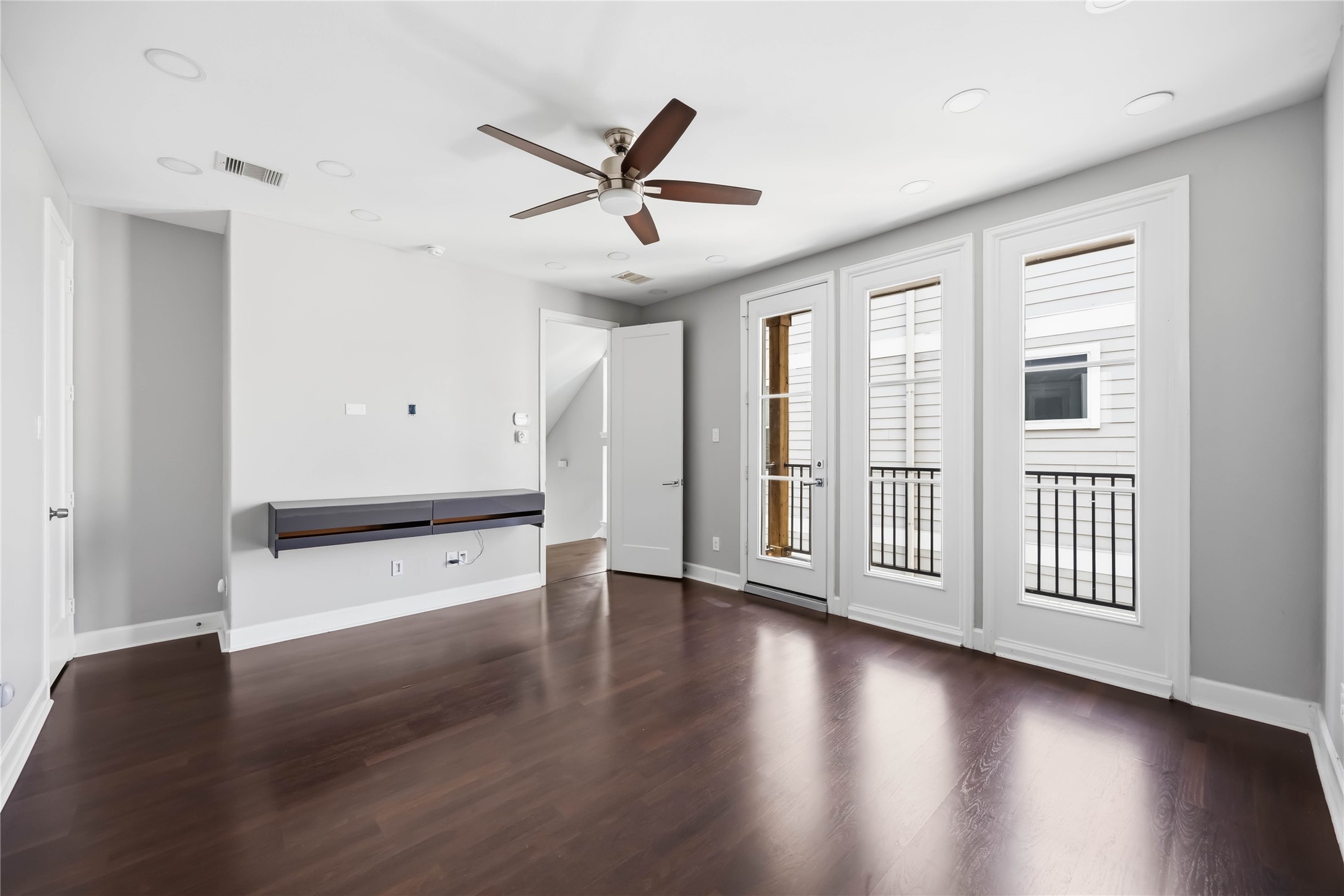 708 Schwartz Street Houston, TX 77020 - Photo 7 of 25 a view of an empty room with wooden floor and a window