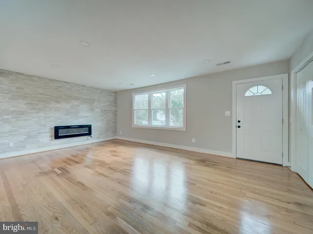 a view of an empty room and wooden floor
