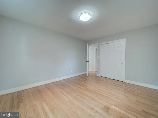 a view of a kitchen with wooden floor electronic appliances and stairs