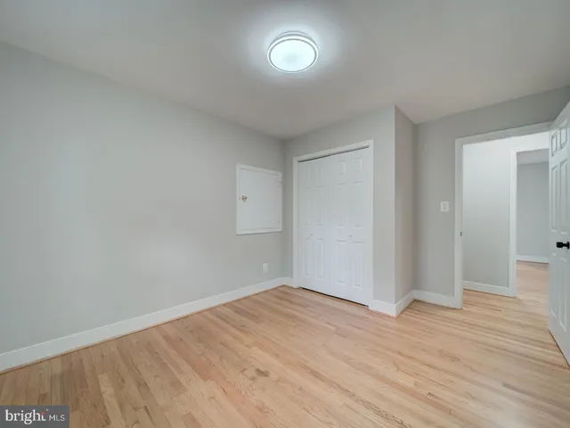 a view of a storage & utility room with closet window