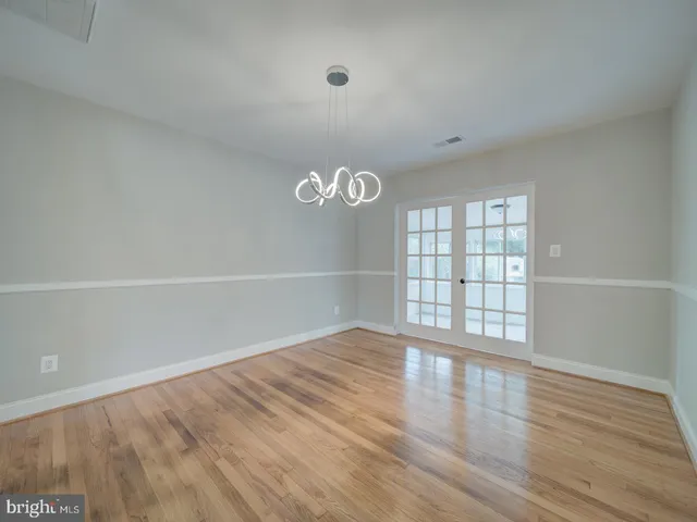 a kitchen with cabinets stainless steel appliances a sink and a window