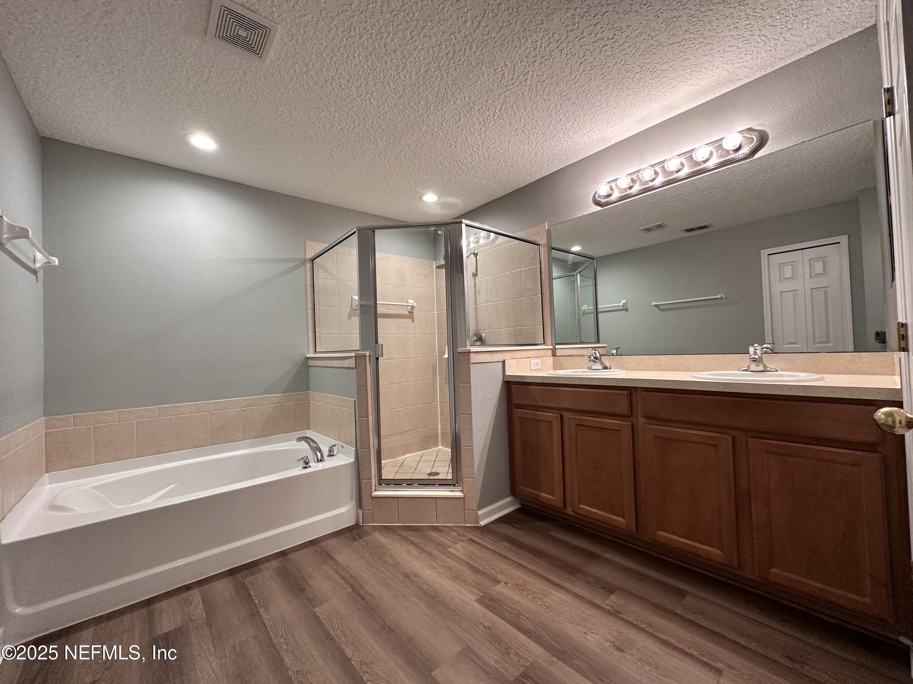 3730 Creswick Circle, Unit 5 Orange Park, FL 32065 - Photo 11 of 18 a spacious bathroom with a tub sink and mirror