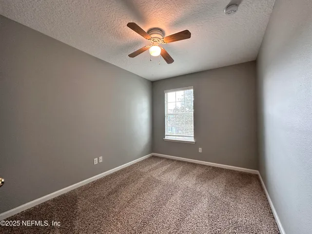 a view of room with window and ceiling fan