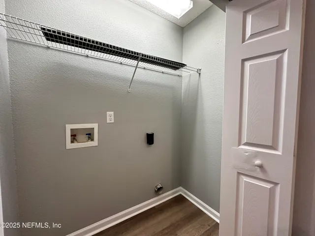 a view of a small space with wooden floor