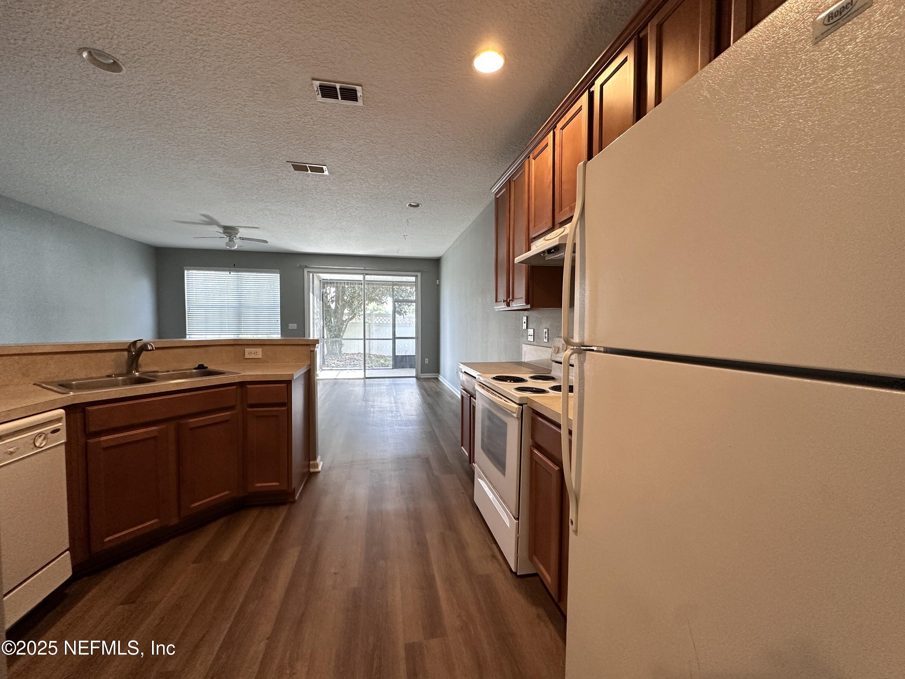 3730 Creswick Circle, Unit 5 Orange Park, FL 32065 - Photo 3 of 18 a kitchen with stainless steel appliances granite countertop a refrigerator a stove and a wooden floors