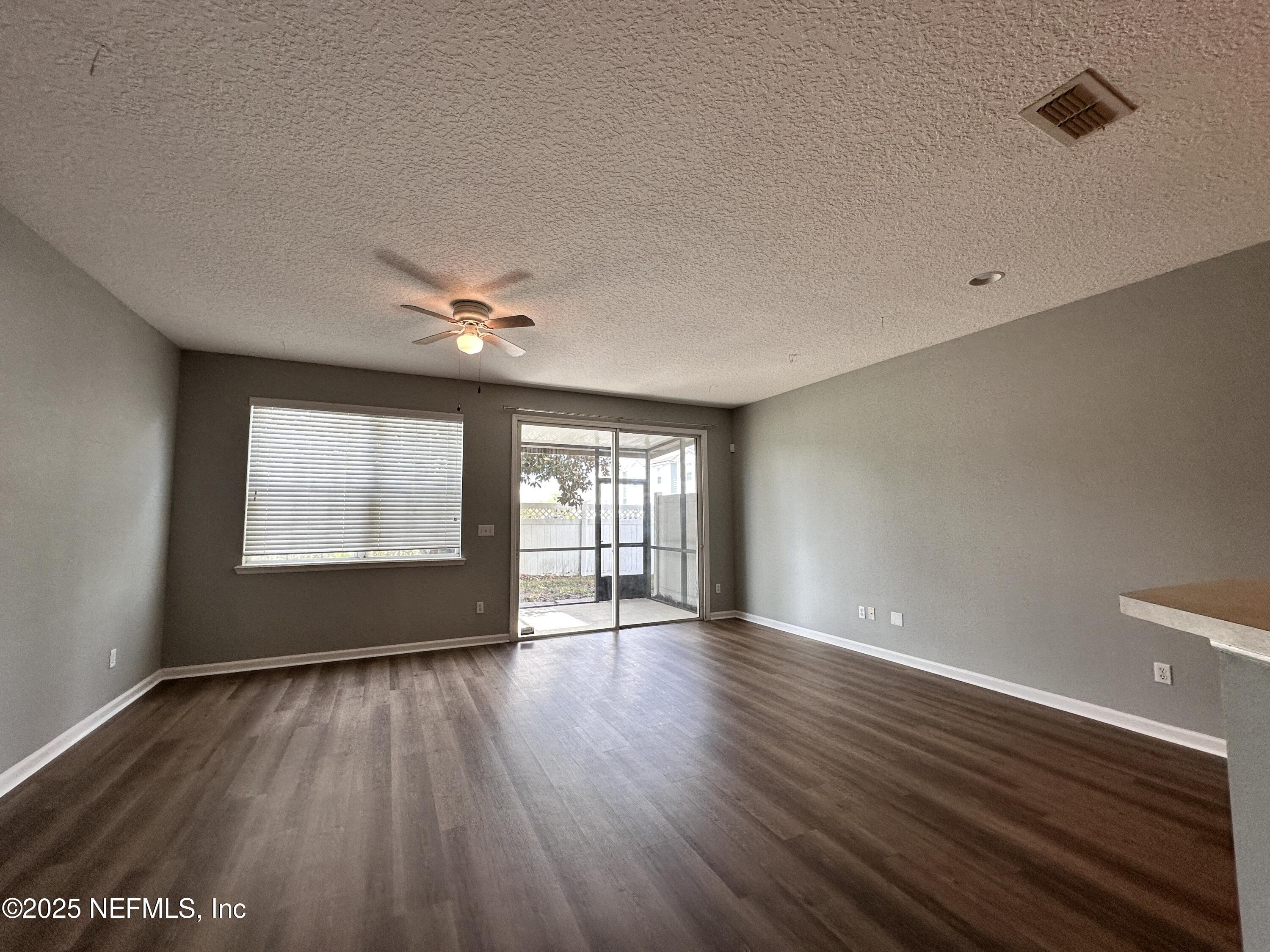 3730 Creswick Circle, Unit 5 Orange Park, FL 32065 - Photo 6 of 18 a view of an empty room with wooden floor and a window