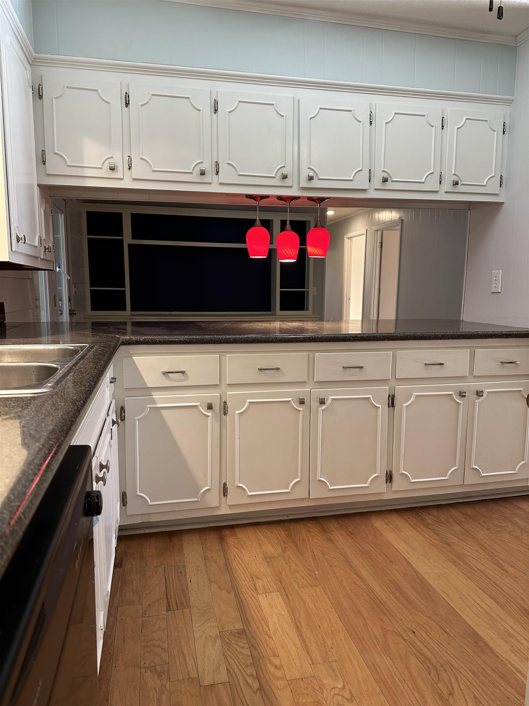 141 Pecan Street Selmer, TN 38375 - Photo 11 of 35 a kitchen with stainless steel appliances granite countertop a sink and cabinets with wooden floor