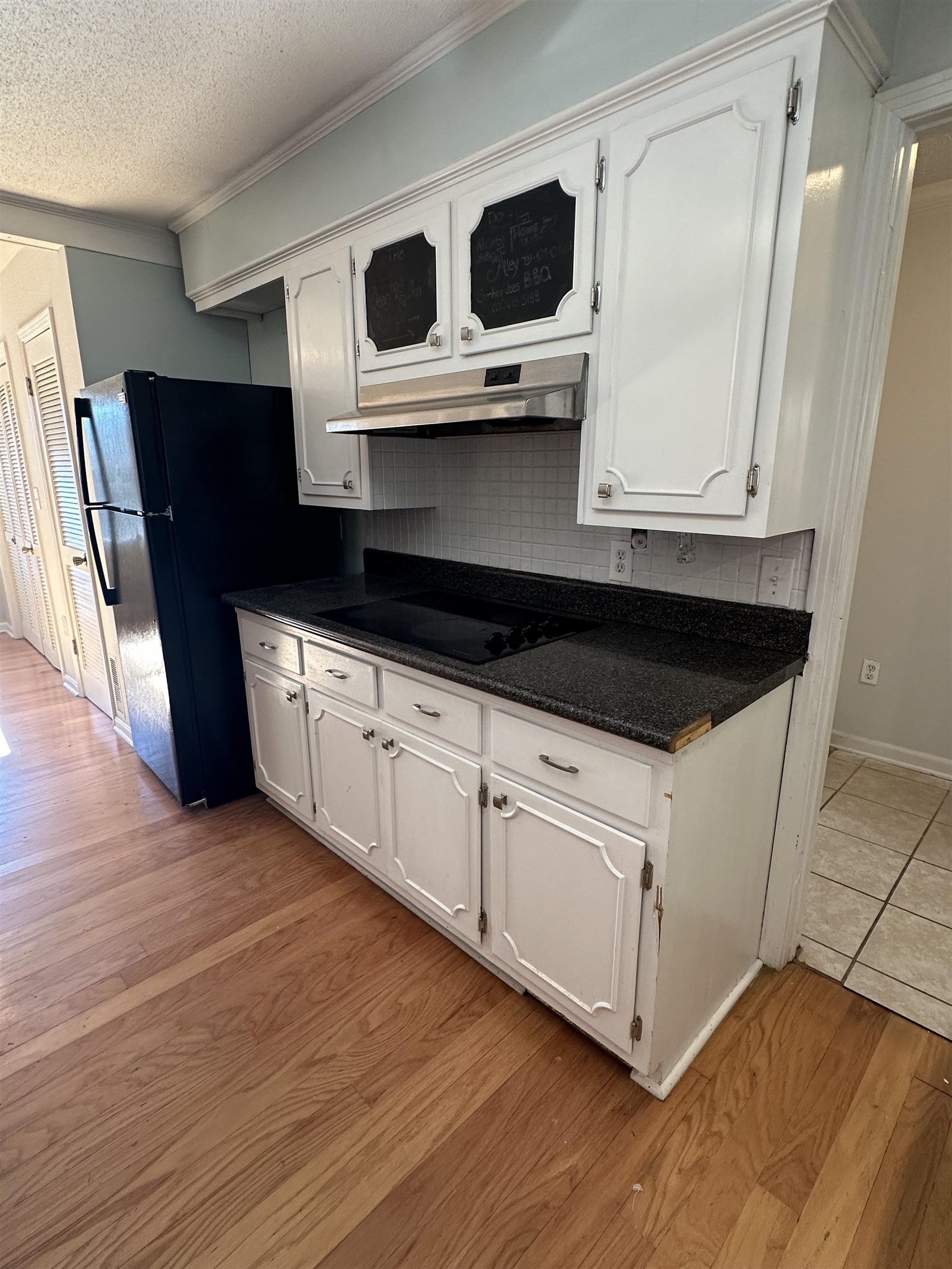 141 Pecan Street Selmer, TN 38375 - Photo 13 of 35 a kitchen with stainless steel appliances granite countertop a stove a microwave and a wooden cabinets
