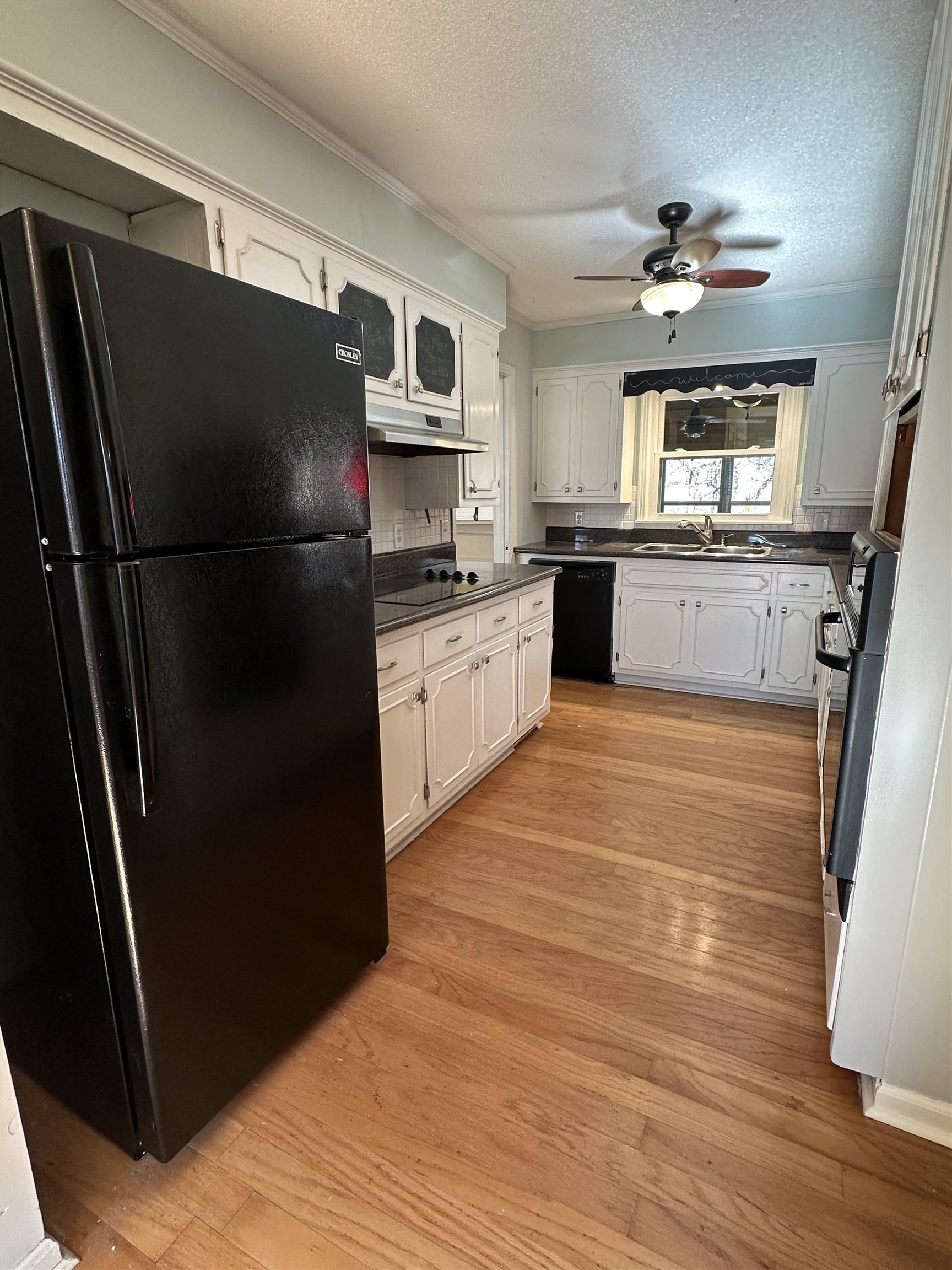 141 Pecan Street Selmer, TN 38375 - Photo 14 of 35 a kitchen with granite countertop a refrigerator stove and sink