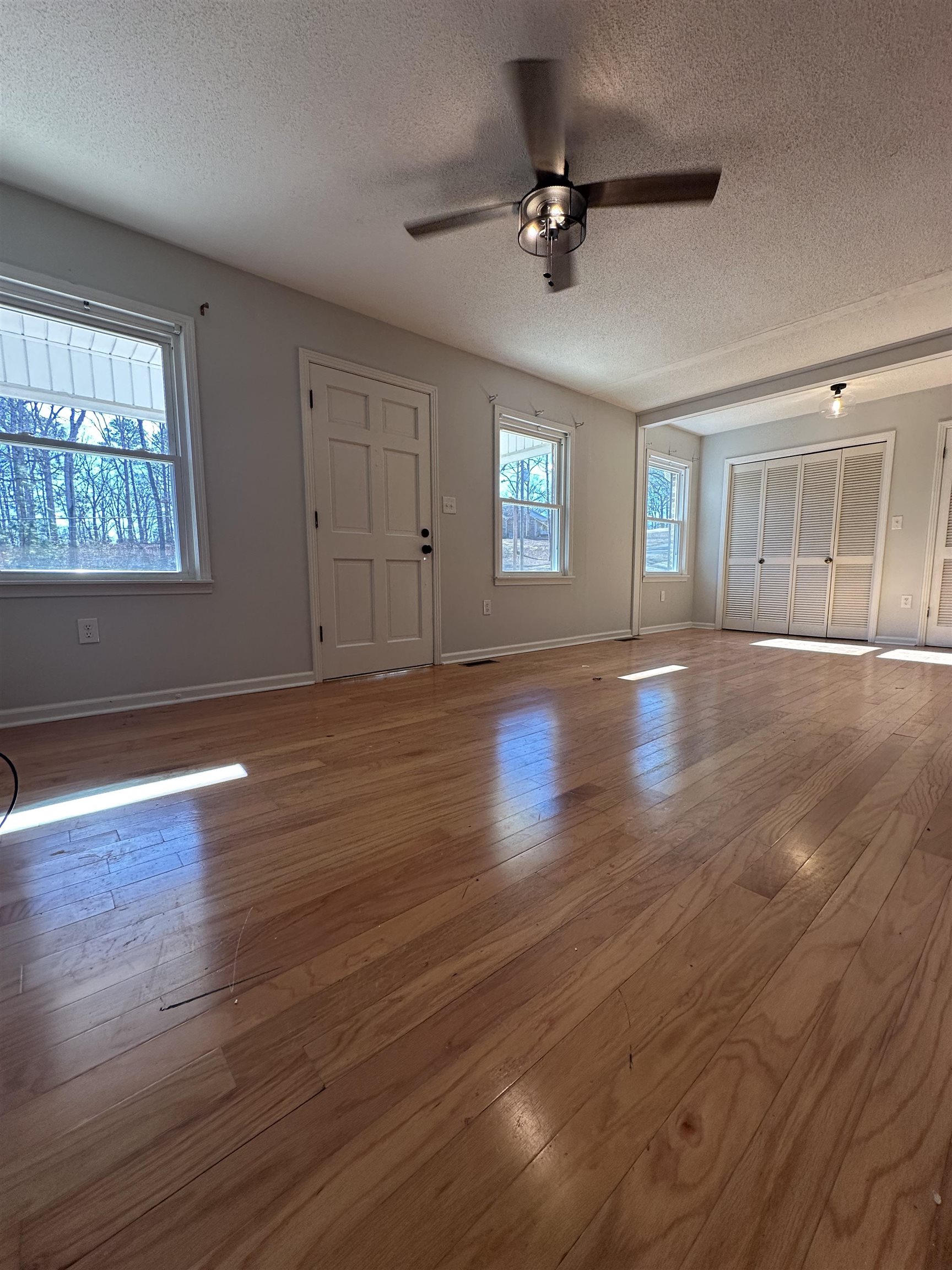 141 Pecan Street Selmer, TN 38375 - Photo 17 of 35 a view of an empty room with wooden floor and a window
