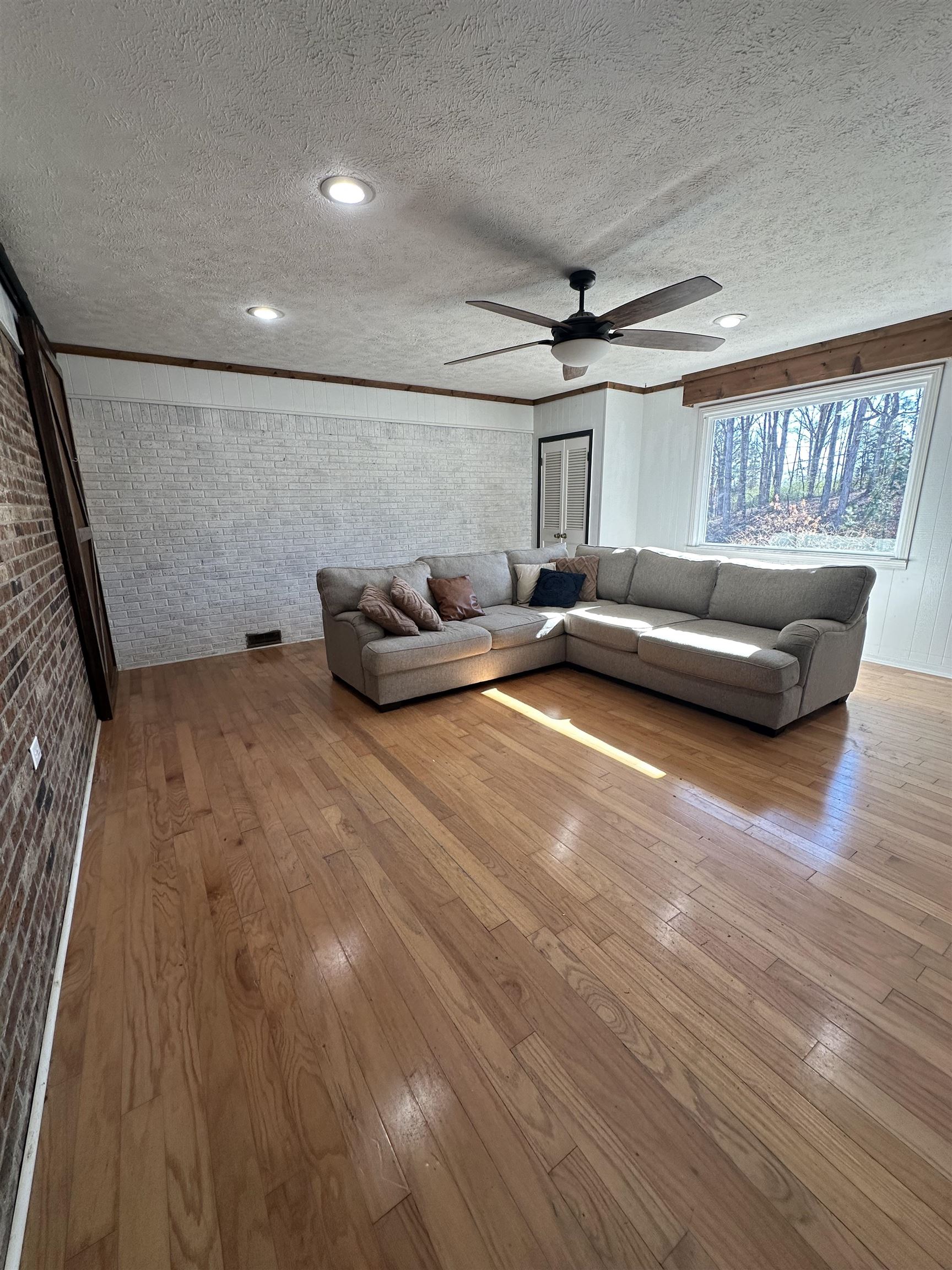 141 Pecan Street Selmer, TN 38375 - Photo 2 of 35 a living room with furniture and a wooden floor
