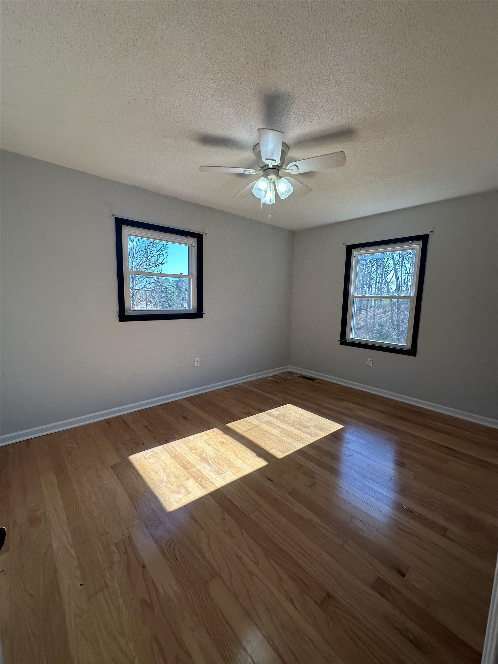 141 Pecan Street Selmer, TN 38375 - Photo 28 of 35 a view of empty room with wooden floor and fan