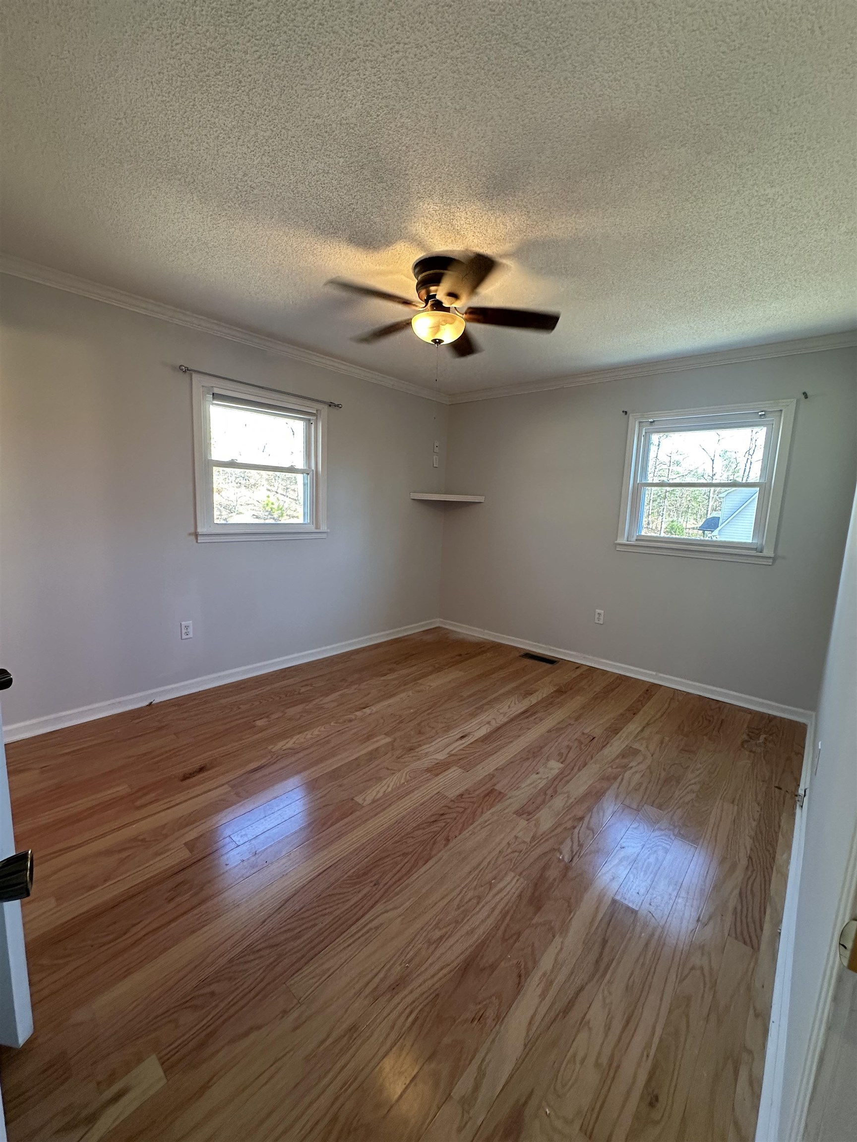 141 Pecan Street Selmer, TN 38375 - Photo 30 of 35 a view of an empty room with window and chandelier fan