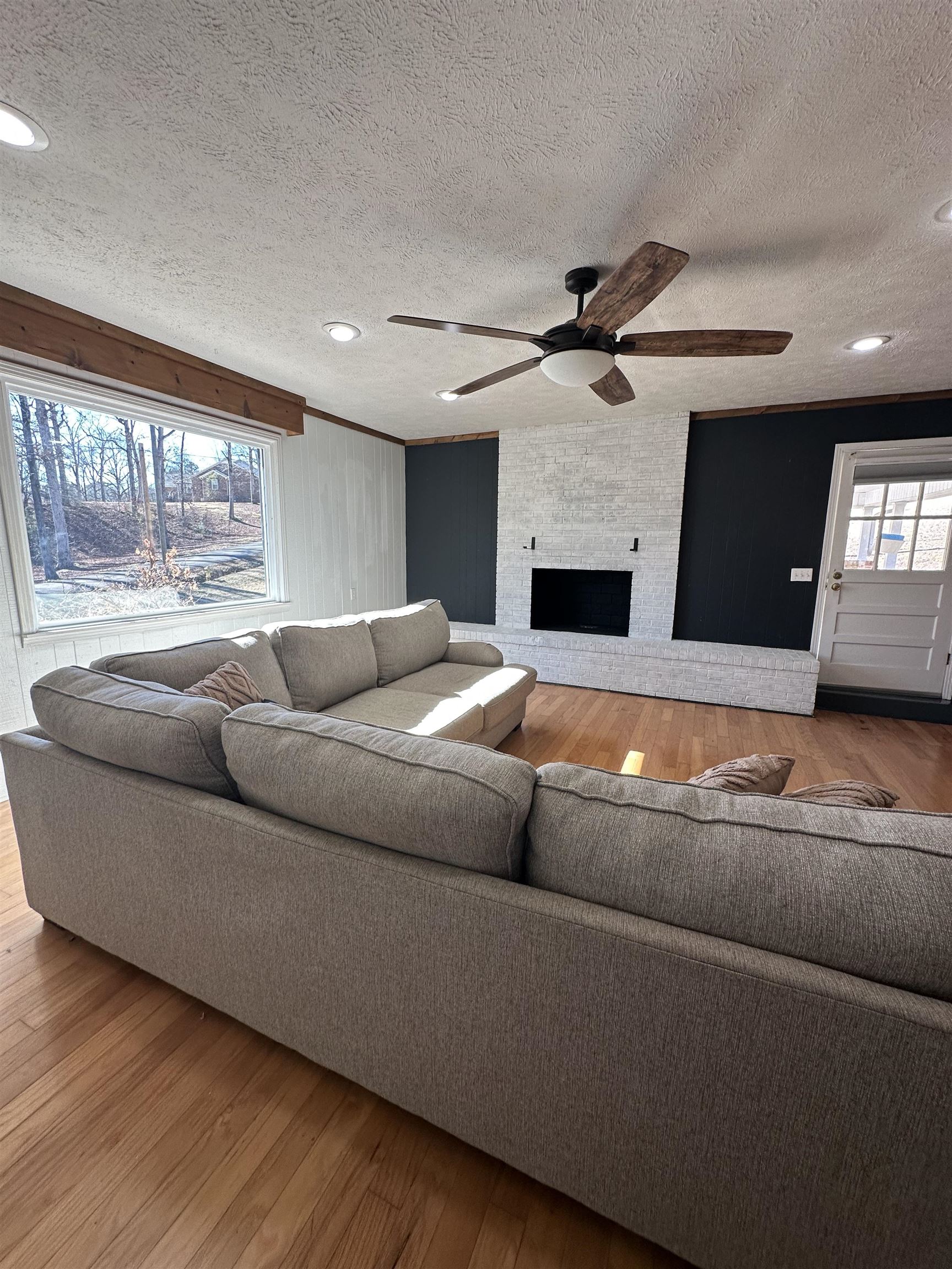 141 Pecan Street Selmer, TN 38375 - Photo 5 of 35 a living room with a couch and a fireplace