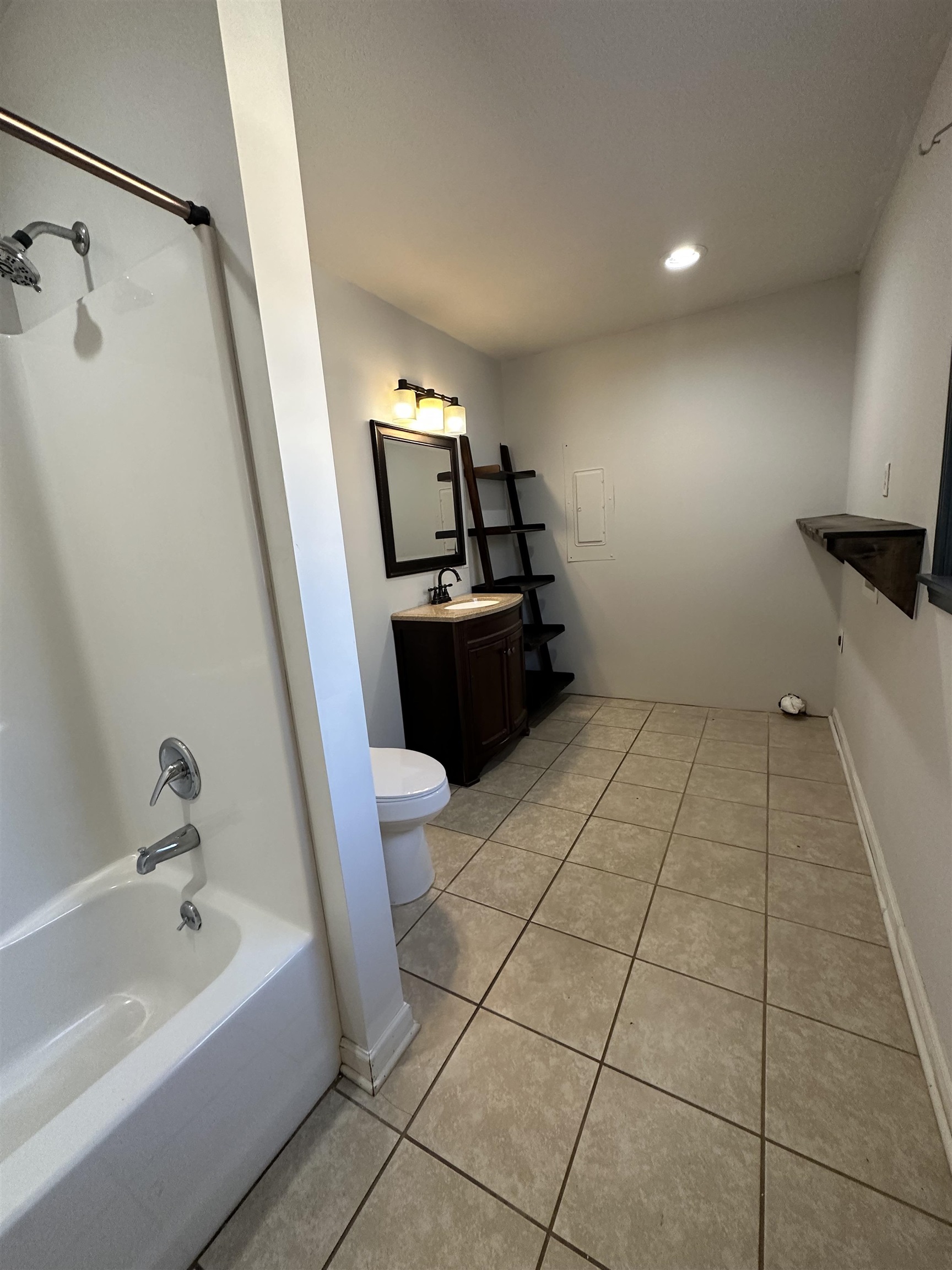 141 Pecan Street Selmer, TN 38375 - Photo 6 of 35 a bathroom with a sink a toilet and bathtub