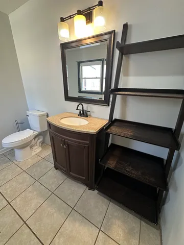 a bathroom with a sink a toilet and mirror