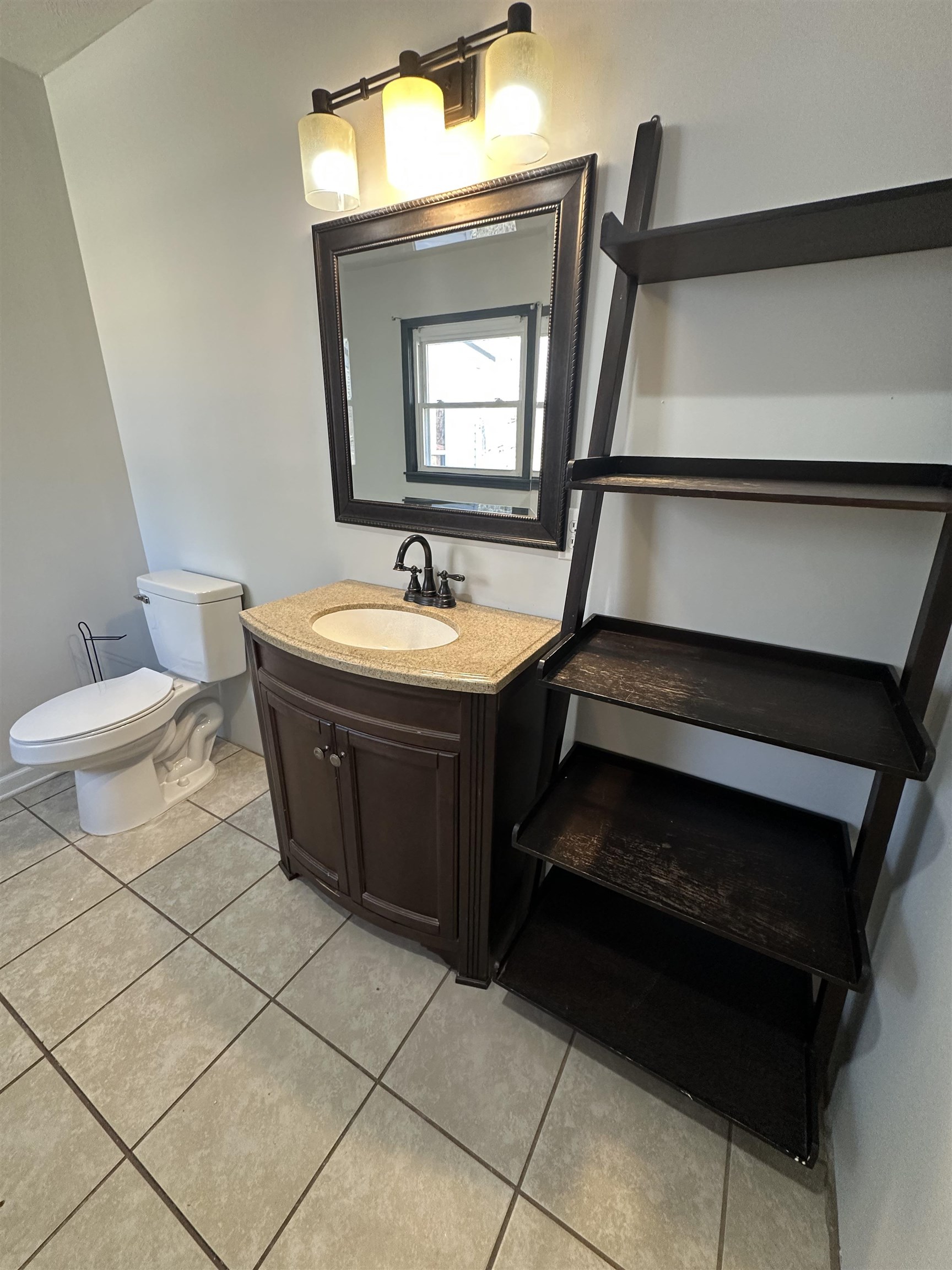 141 Pecan Street Selmer, TN 38375 - Photo 7 of 35 a bathroom with a sink a toilet and mirror