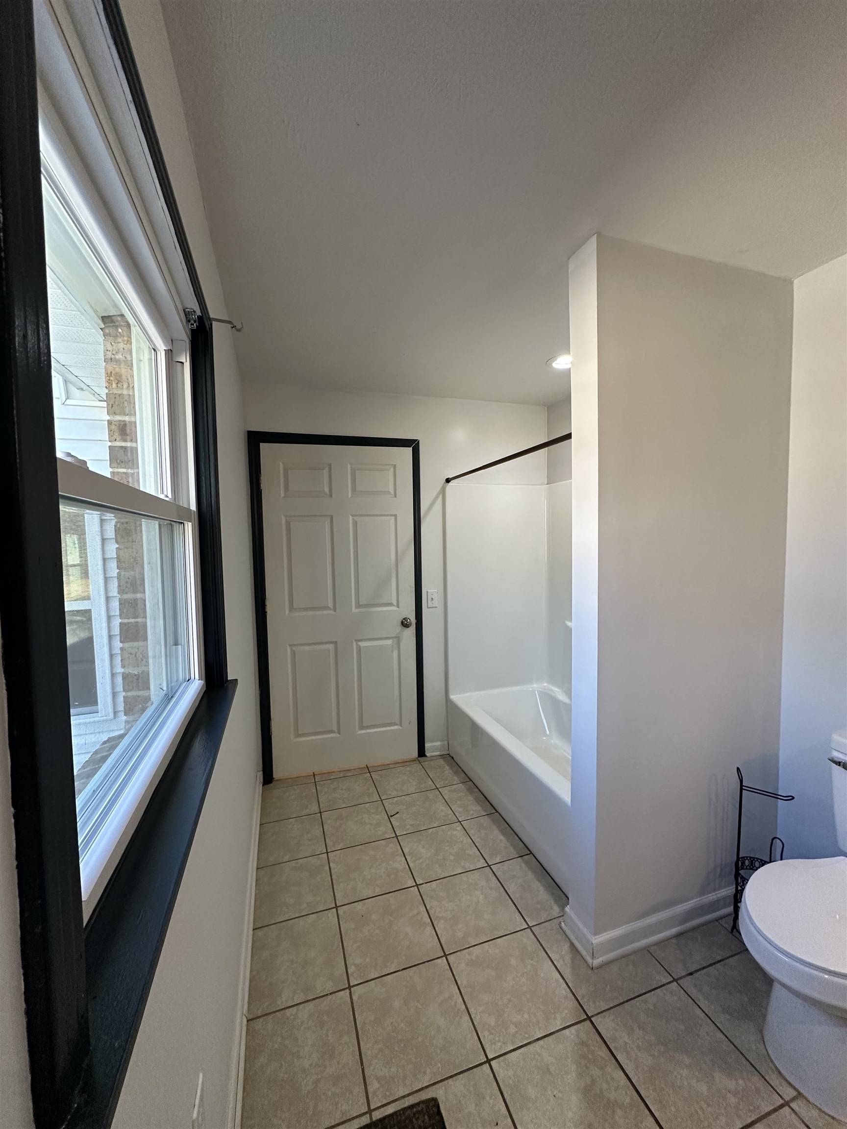 141 Pecan Street Selmer, TN 38375 - Photo 8 of 35 a bathroom with a glass door shower and toilet