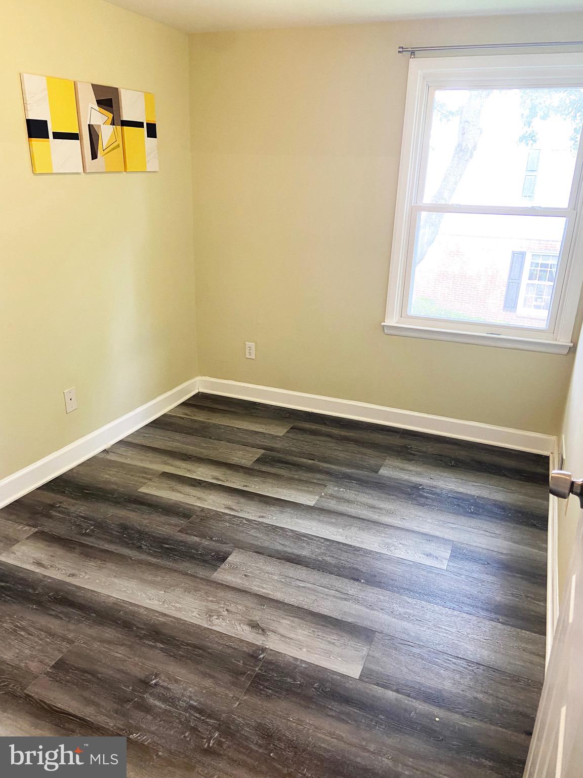 8549 Ramort Drive, Unit 23A Nottingham, MD 21236 - Photo 11 of 18 a view of a room with wooden floor and a window