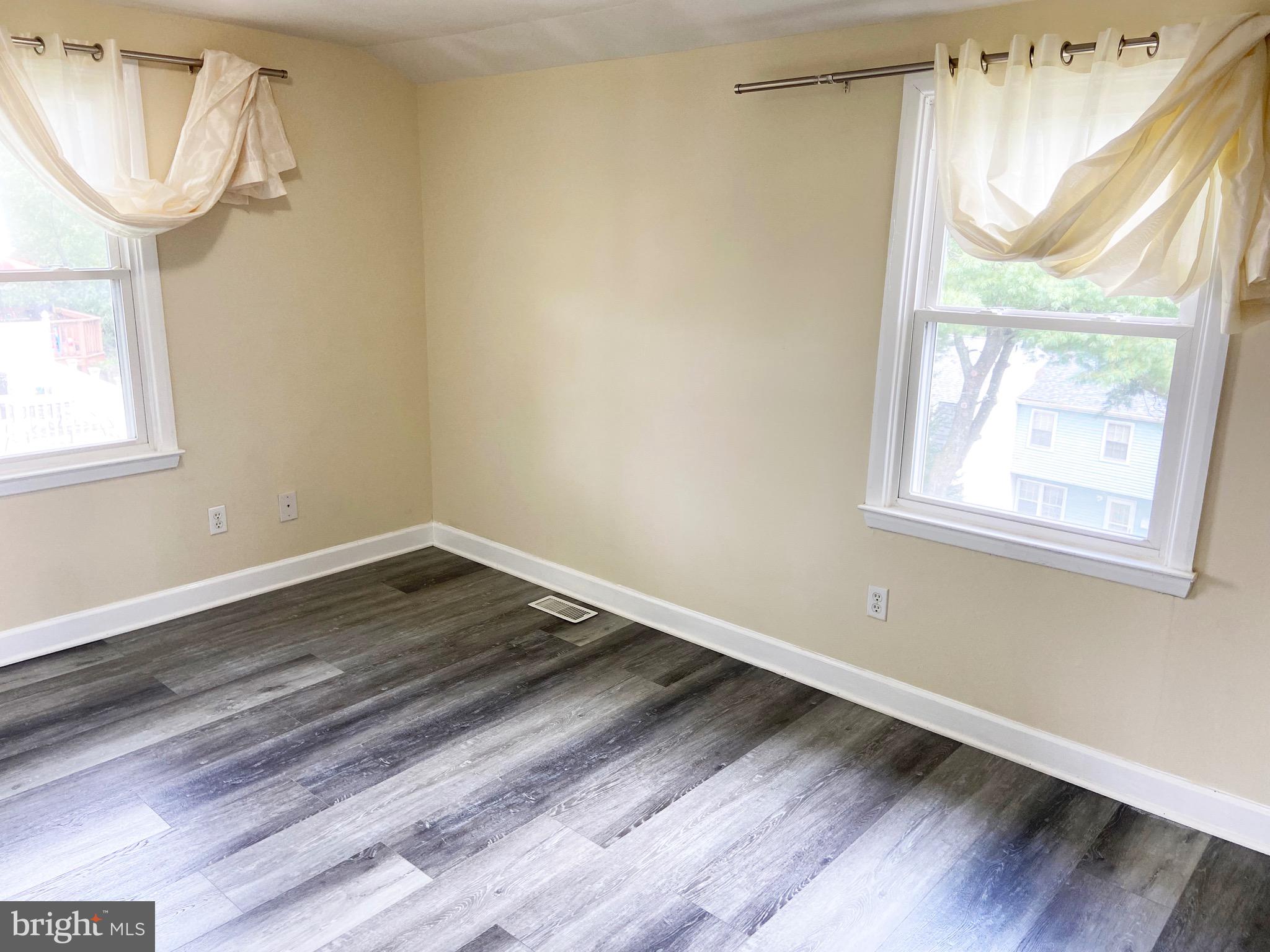 8549 Ramort Drive, Unit 23A Nottingham, MD 21236 - Photo 12 of 18 a view of empty room with wooden floor and fan