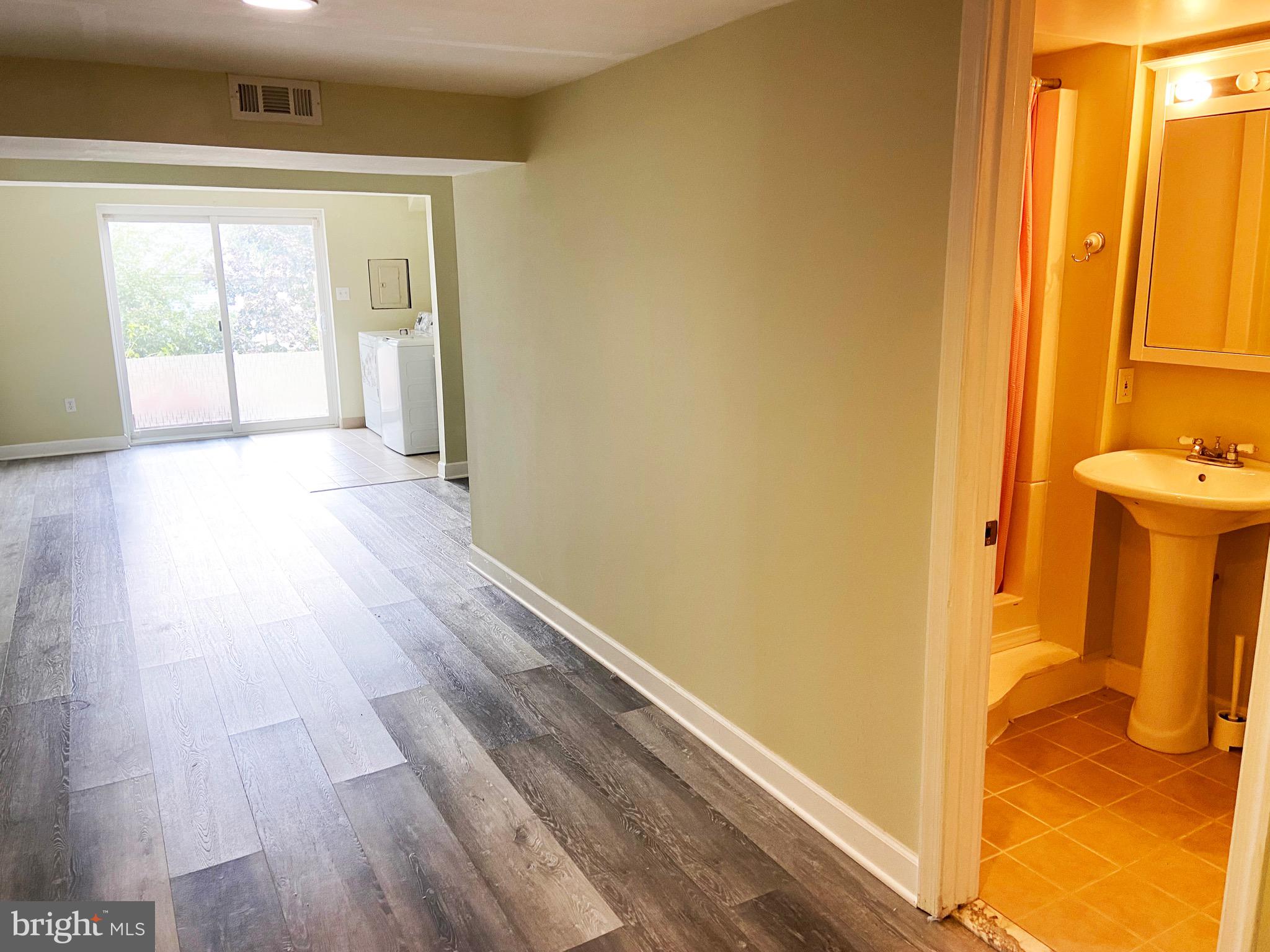 8549 Ramort Drive, Unit 23A Nottingham, MD 21236 - Photo 15 of 18 a view of a bathroom with wooden floor and a sink