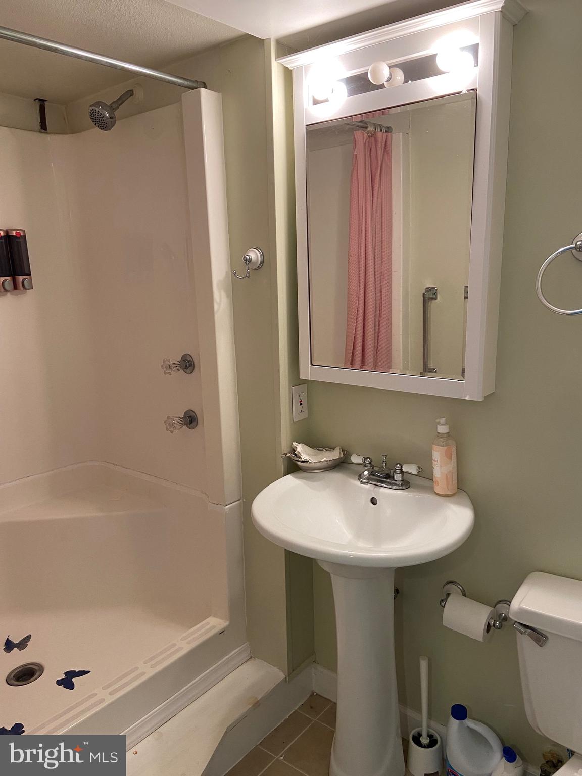 8549 Ramort Drive, Unit 23A Nottingham, MD 21236 - Photo 16 of 18 a bathroom with a sink a toilet and shower
