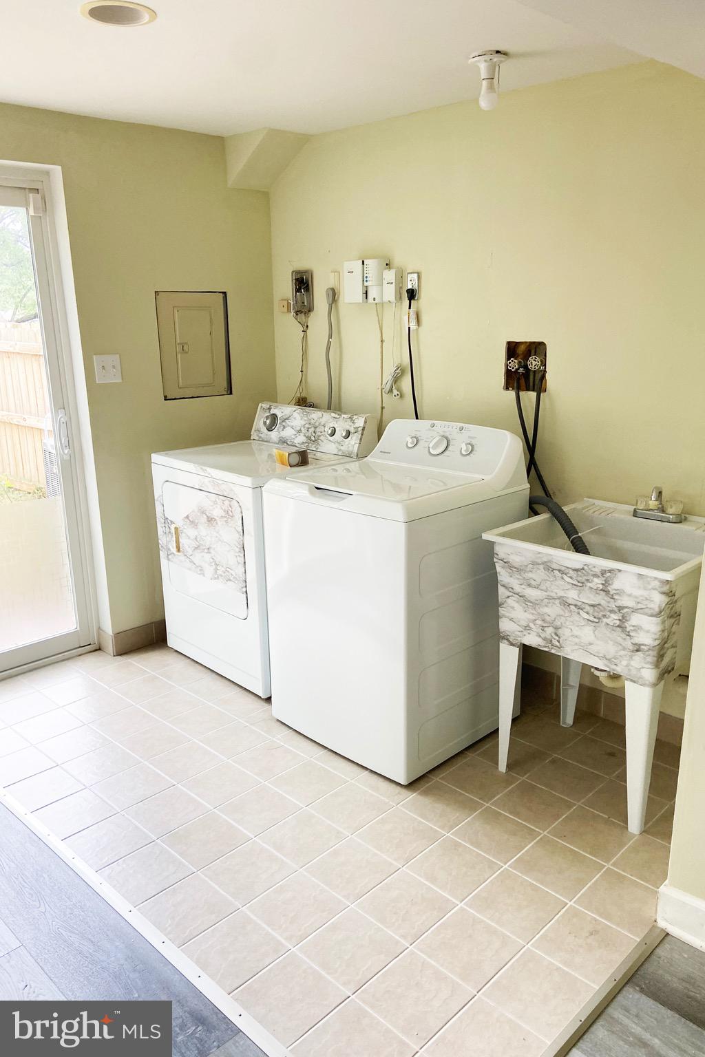 8549 Ramort Drive, Unit 23A Nottingham, MD 21236 - Photo 17 of 18 a utility room with a sink a washer and dryer