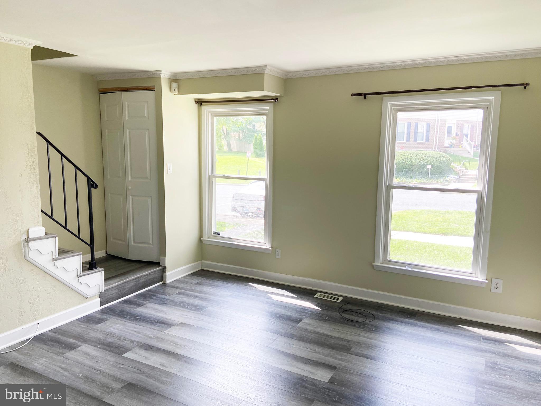 8549 Ramort Drive, Unit 23A Nottingham, MD 21236 - Photo 2 of 18 an empty room with wooden floor and windows