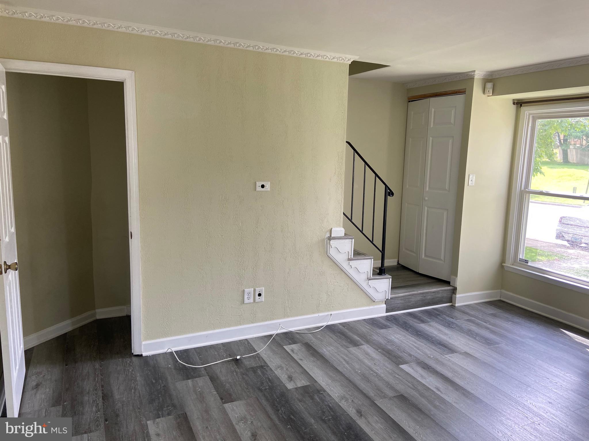8549 Ramort Drive, Unit 23A Nottingham, MD 21236 - Photo 3 of 18 an empty room with wooden floor and a window
