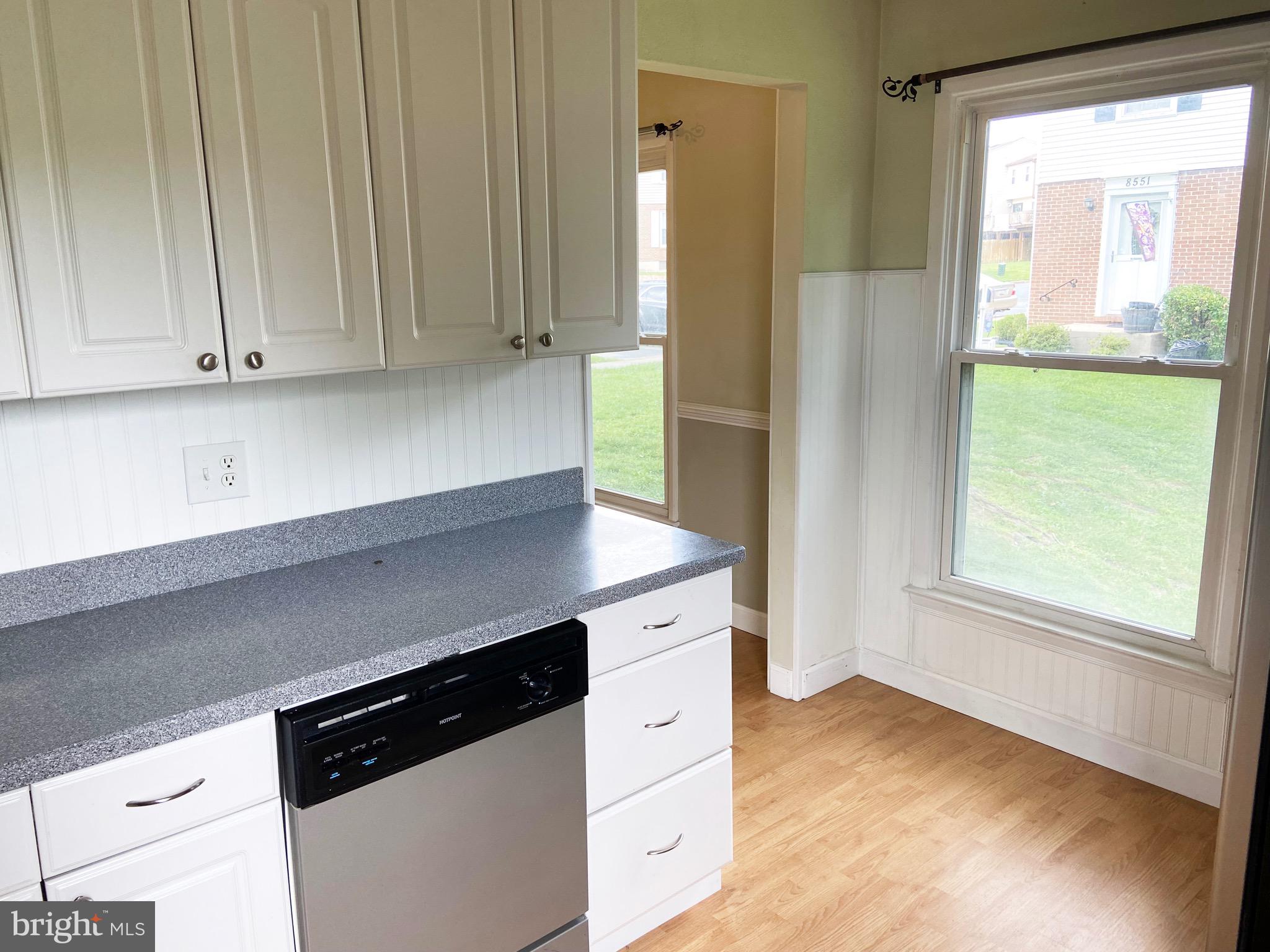 8549 Ramort Drive, Unit 23A Nottingham, MD 21236 - Photo 6 of 18 a kitchen with granite countertop white cabinets and black appliances