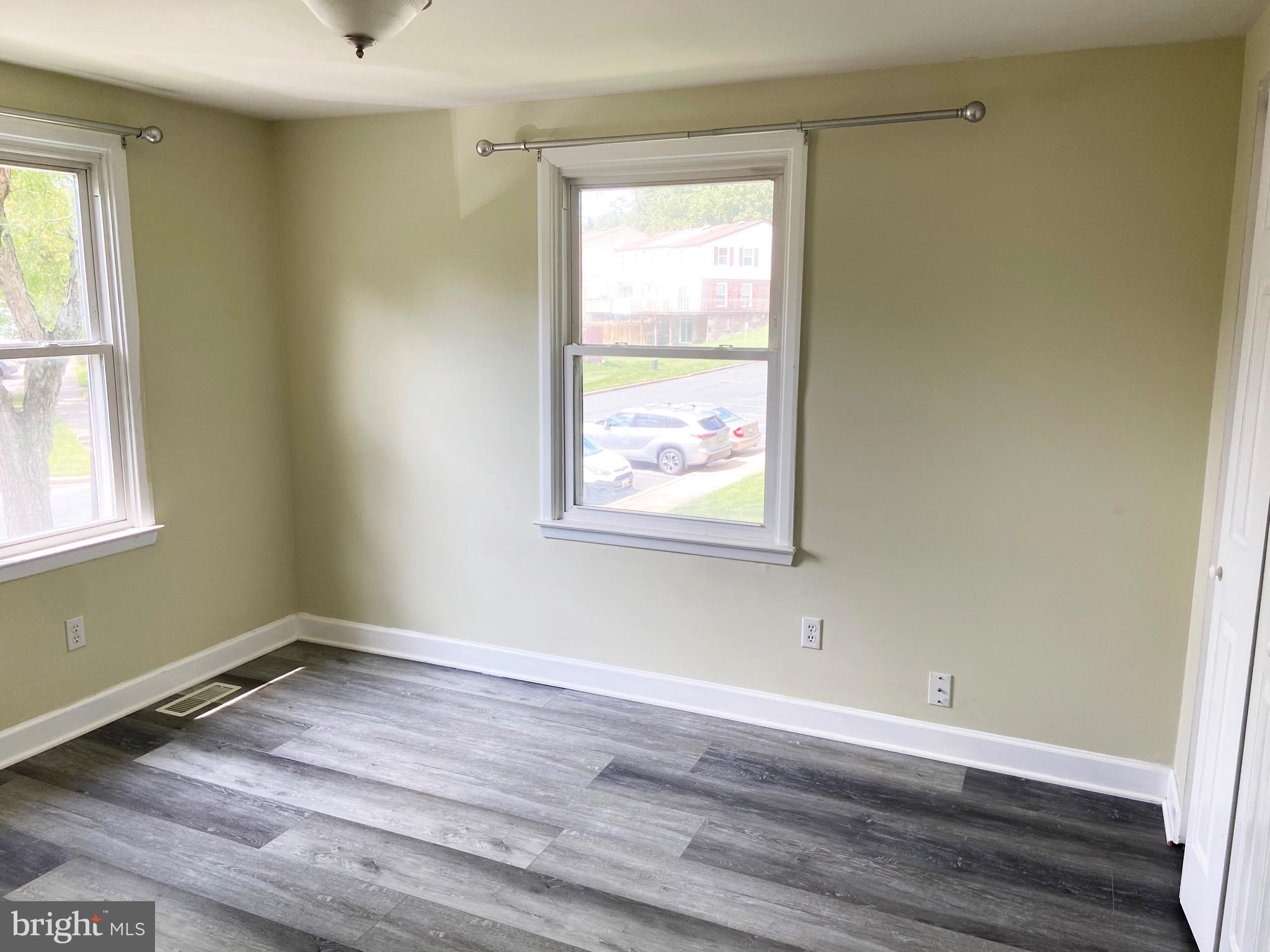 8549 Ramort Drive, Unit 23A Nottingham, MD 21236 - Photo 10 of 18 an empty room with wooden floor and windows