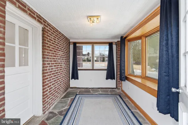 a view of an entryway with wooden floor and door