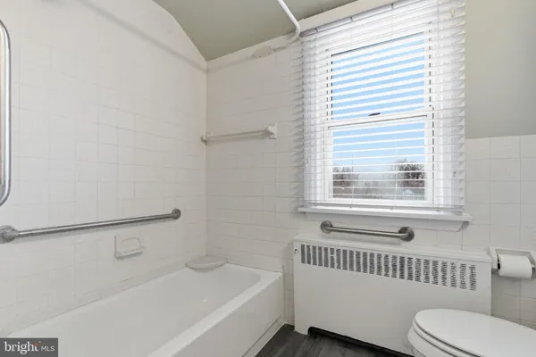 a bathroom with a bathtub and a window