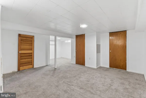 a view of an empty room with a fireplace
