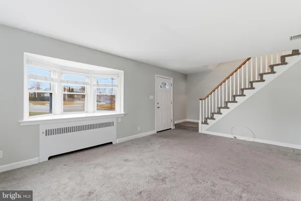 a view of an empty room with stairs