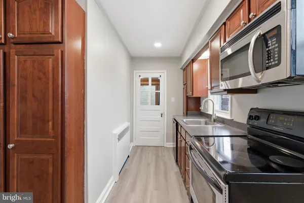 a kitchen with stainless steel appliances granite countertop a stove and a refrigerator